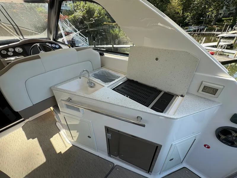 Slide: The Image of 2016 Regal 35 Sport Coupe interior with kitchenette, sink, and grill. - 14