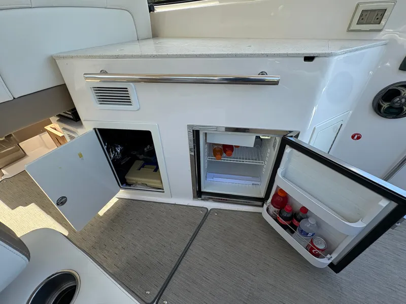 Slide: The Image of 2016 Regal 35 Sport Coupe interior with open mini fridge and storage compartments. - 17