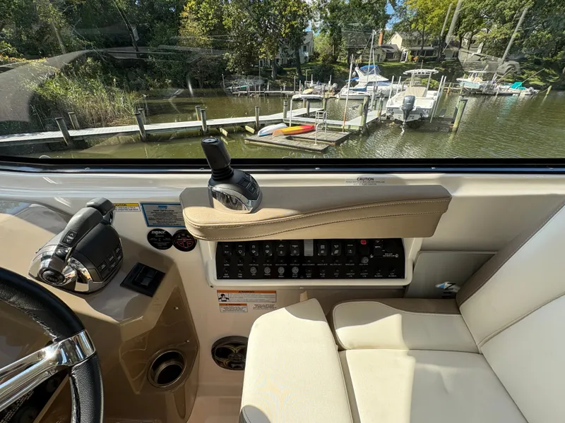 Slide: The Image of Interior view of 2016 Regal 35 Sport Coupe cockpit with control panel and waterfront scenery. - 21