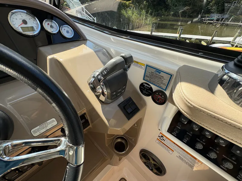 Slide: The Image of Control panel of a 2016 Regal 35 Sport Coupe boat with steering wheel and throttle. - 23