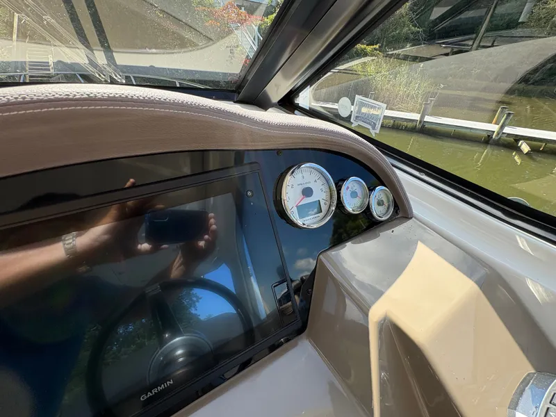 Slide: The Image of Dashboard of a 2016 Regal 35 Sport Coupe with gauges and Garmin display. - 24