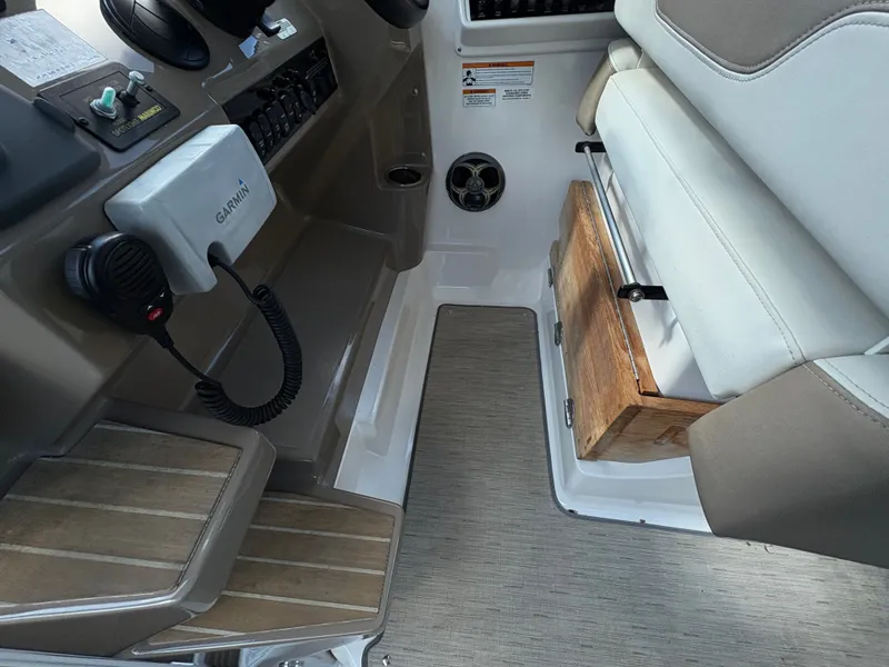 Slide: The Image of 2016 Regal 35 Sport Coupe helm with Garmin device and cushioned seating. - 30