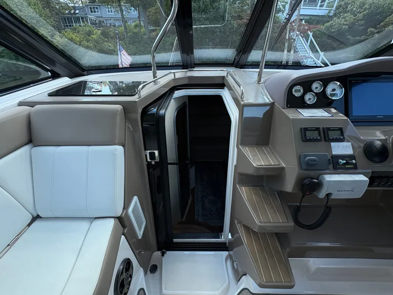 Slide: The Image of Interior view of a 2016 Regal 35 Sport Coupe boat cockpit with seating and control panel. - 32