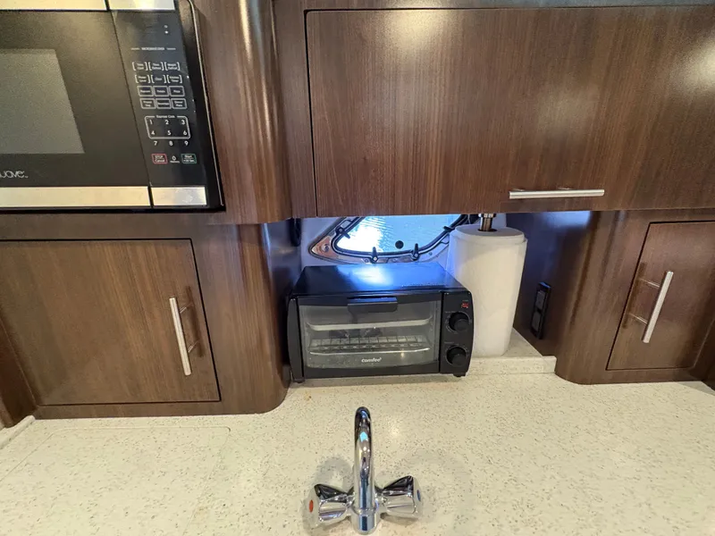 Slide: The Image of 2016 Regal 35 Sport Coupe kitchen with microwave, toaster oven, and sink. - 42