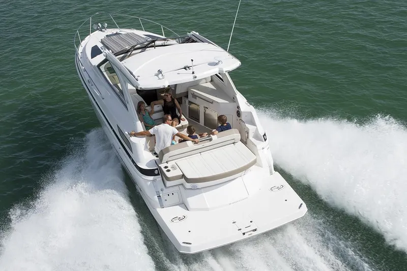 Slide: The Image of 2016 Regal 35 Sport Coupe cruising with passengers on open water. - 58