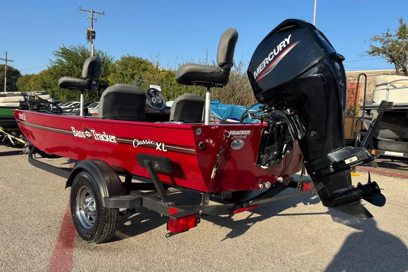 Slide: The Image of 2024 Bass Tracker XL boat with Mercury outboard motor in parking lot. - 11
