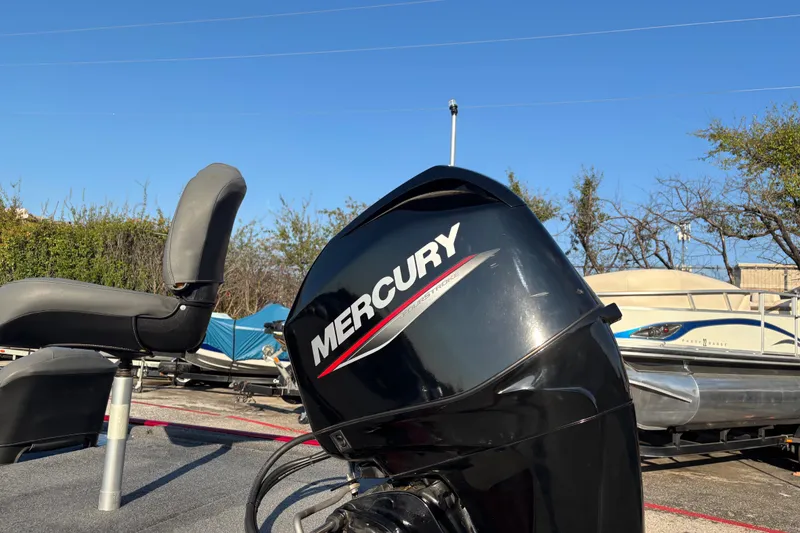 Slide: The Image of 2024 Bass Tracker XL boat interior with seating and steering console. - 12