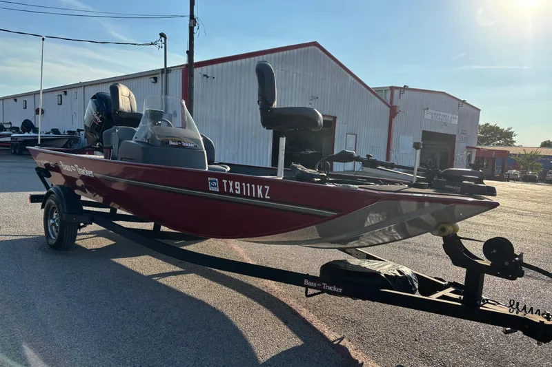 Slide: The Image of 2024 Bass Tracker XL boat interior with seating and fishing equipment. - 18