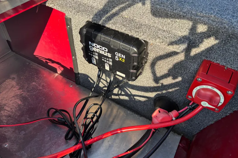 Slide: The Image of 2024 Bass Tracker XL storage compartment with open lid, showcasing interior space. - 25