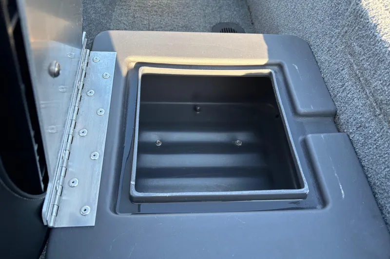 Slide: The Image of 2024 Bass Tracker XL storage compartment with open lid, showcasing interior space. - 29