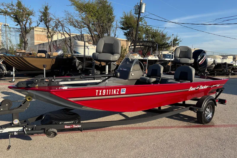 Slide: The Image of 2024 Bass Tracker XL boat with 50 HP engine, parked in a lot. - 3