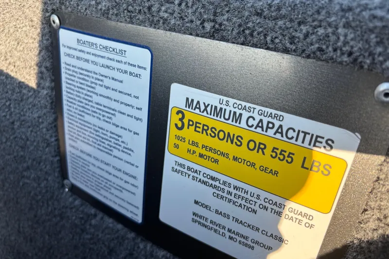 Slide: The Image of 2024 Bass Tracker XL trailer wheel with black fender and chrome hubcap. - 32