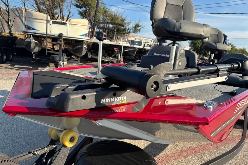 Slide: The Image of 2024 Bass Tracker XL boat on trailer, parked outdoors in sunlight. - 5