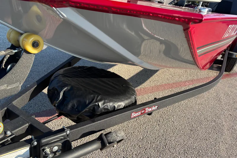 Slide: The Image of 2024 Bass Tracker XL boat with seating, parked outdoors under clear sky. - 7