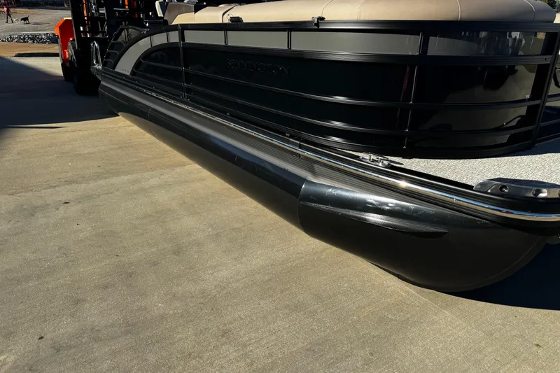 Slide: The Image of 2025 Bennington 23RSB pontoon boat on a trailer, side view. - 1