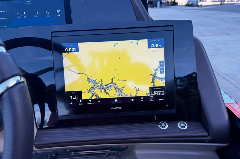 Slide: The Image of Garmin navigation display on 2025 Bennington 23RSB boat dashboard, showing map and GPS data. - 12