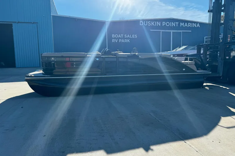 Slide: The Image of 2025 Bennington 23RSB pontoon boat at Duskin Point Marina under sunlight. - 2