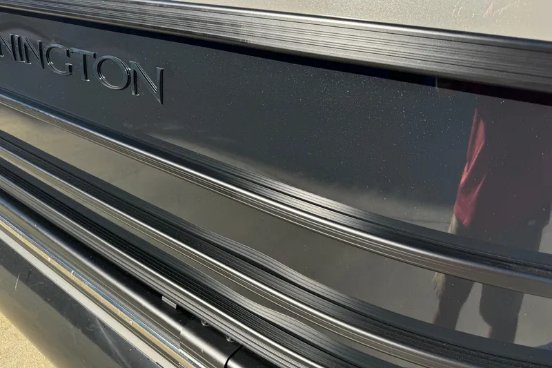 Slide: The Image of 2025 Bennington 23RSB boat exterior with sleek black finish and embossed logo. - 3