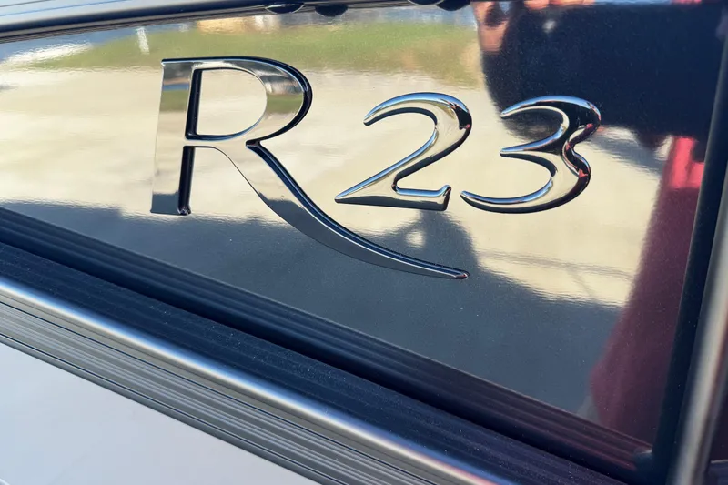 Slide: The Image of Close-up of 2025 Bennington 23RSB model emblem on a sleek surface. - 6