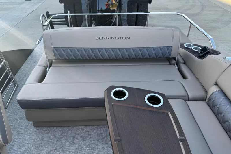 Slide: The Image of 2025 Bennington 23RSB boat interior with cushioned seating and cup holders. - 7