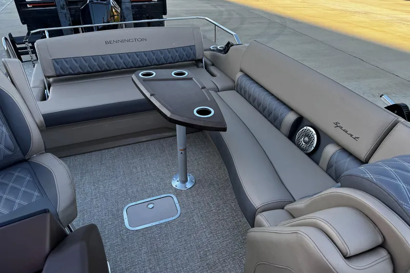 Slide: The Image of 2025 Bennington 23RSB boat interior with luxurious seating and table setup. - 8