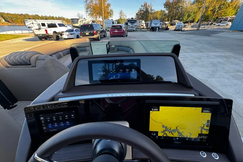 Slide: The Image of 2025 Bennington 23RSB boat dashboard with navigation screens and steering wheel. - 9