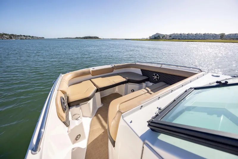 Slide: The Image of 2019 Sea Ray SDX 250 Outboard boat interior with tan seating on calm water. - 39