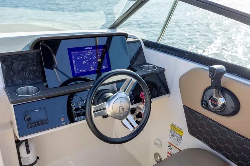 Slide: The Image of 2019 Sea Ray SDX 250 Outboard helm with steering wheel and digital display. - 47