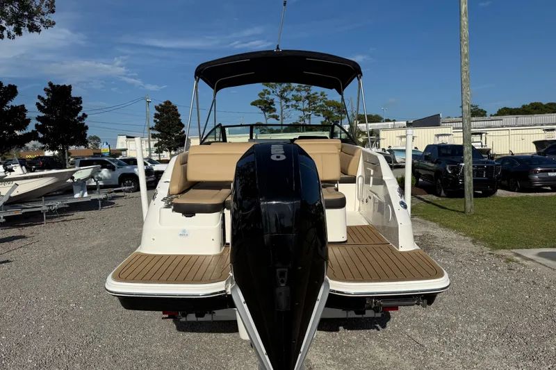 Slide: The Image of 2019 Sea Ray SDX 250 Outboard boat with tan seating, displayed outdoors. - 57