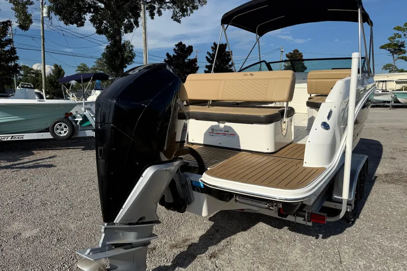 Slide: The Image of 2019 Sea Ray SDX 250 Outboard boat with tan seating and black outboard motor. - 58