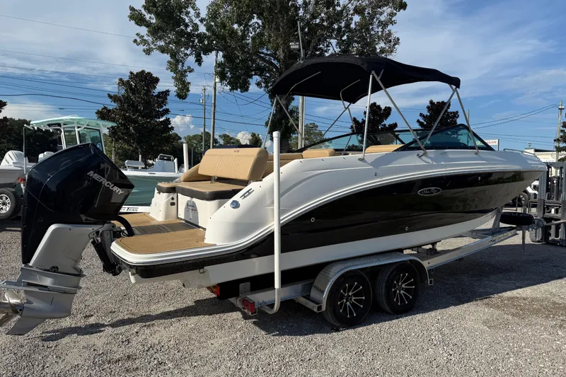 Slide: The Image of 2019 Sea Ray SDX 250 Outboard boat on trailer, featuring a sleek design and Mercury engine. - 59