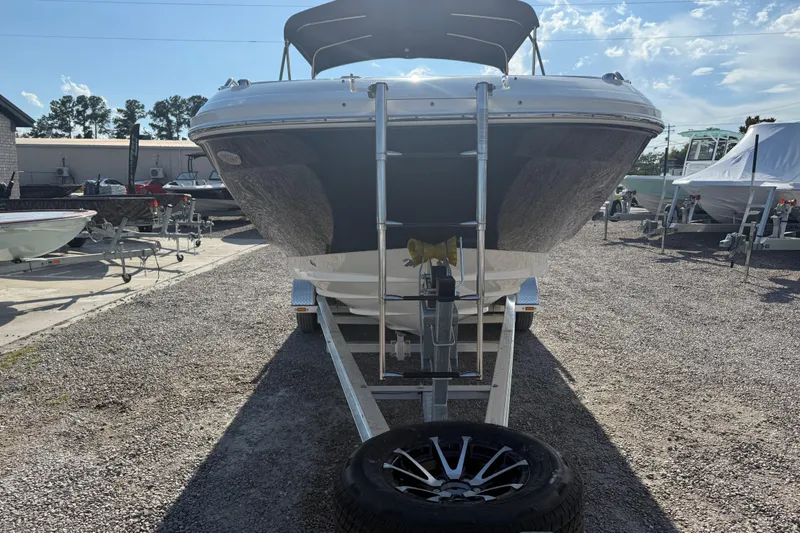 Slide: The Image of 2019 Sea Ray SDX 250 Outboard boat on trailer, parked outdoors under clear sky. - 62
