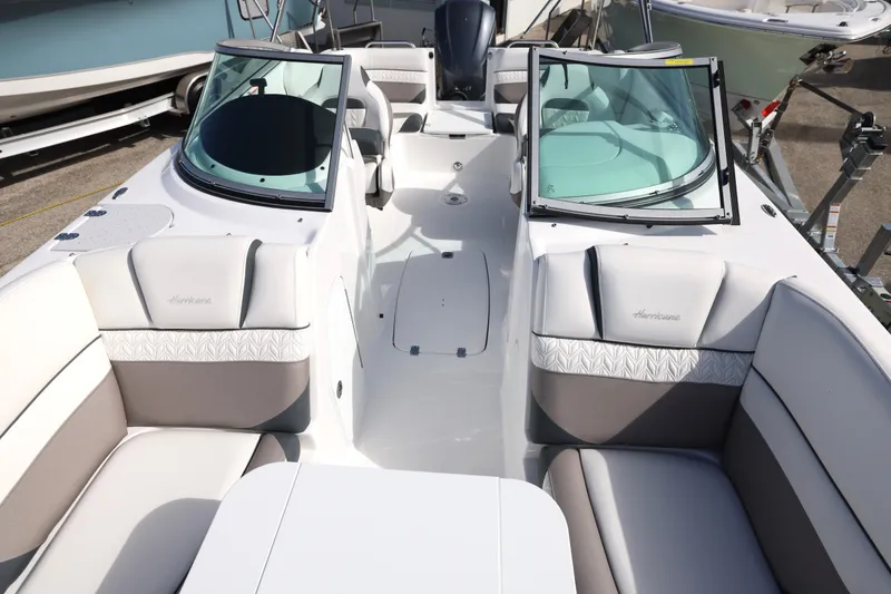 Slide: The Image of 2026 Hurricane SunDeck 2486 OB boat interior with modern seating and sleek design. - 13