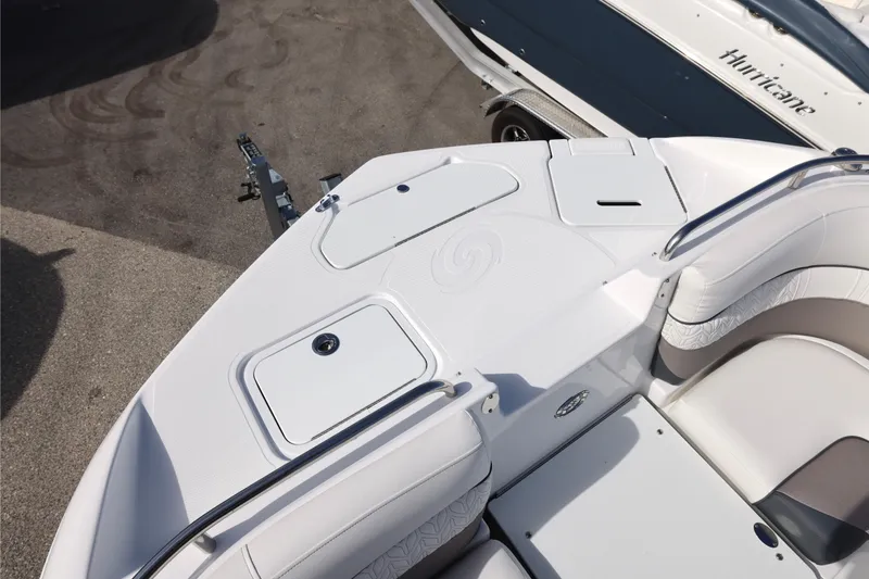 Slide: The Image of 2026 Hurricane SunDeck 2486 OB boat interior with plush seating and dual windshields. - 14