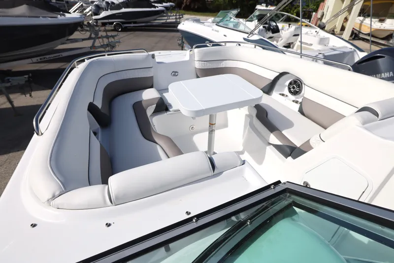 Slide: The Image of 2026 Hurricane SunDeck 2486 OB boat interior with cushioned seating and table. - 17