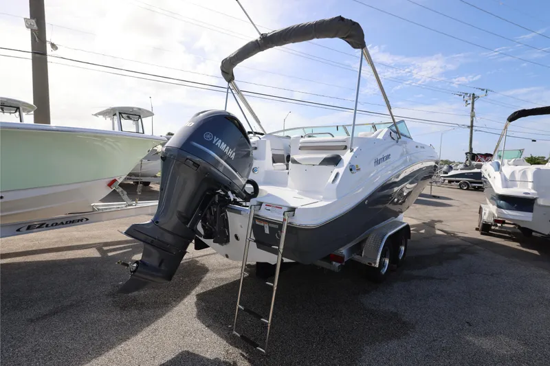 Slide: The Image of 2026 Hurricane SunDeck 2486 OB boat interior with seating and table, showcasing luxury design. - 19
