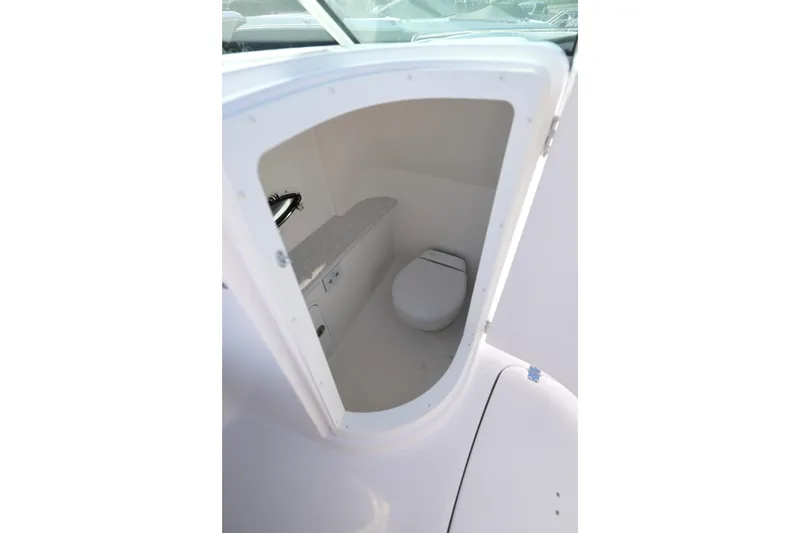Slide: The Image of 2026 Hurricane SunDeck 2486 OB boat interior with spacious seating and table. - 5