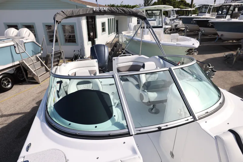 Slide: The Image of 2026 Hurricane SunDeck 2486 OB boat interior with compact marine toilet. - 6