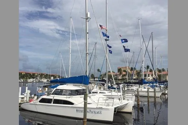 The Image of 2009 Seawind 36 1000XL catamaran docked in a marina with other sailboats. - 0