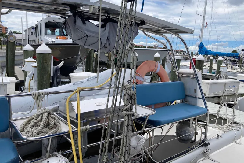 Slide: The Image of 2009 Seawind 36 1000XL catamaran docked at marina with blue seating and lifebuoy. - 10