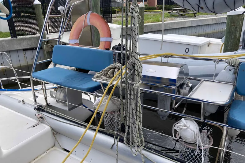 Slide: The Image of 2009 Seawind 36 1000XL sailboat with blue seating and nautical equipment at dock. - 11