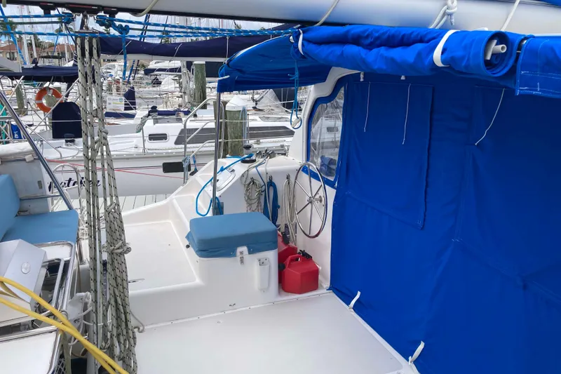 Slide: The Image of 2009 Seawind 36 1000XL catamaran with blue canopy and marina background. - 13