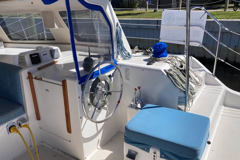 Slide: The Image of 2009 Seawind 36 1000XL cockpit with steering wheel, ropes, and blue seating. - 14