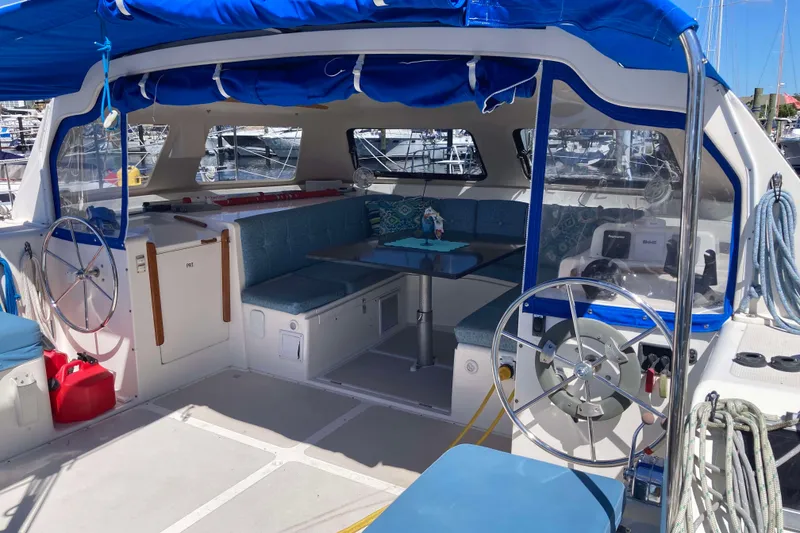 Slide: The Image of 2009 Seawind 36 1000XL catamaran interior with blue seating and dual steering wheels. - 16