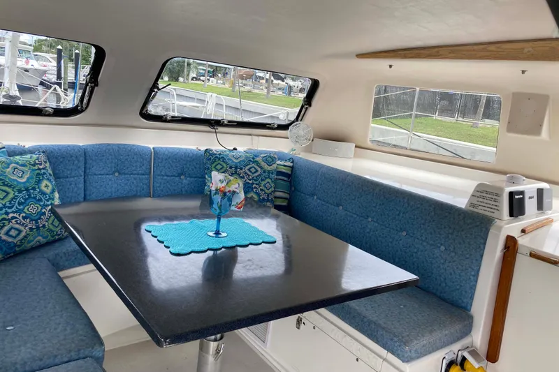 Slide: The Image of Interior of 2009 Seawind 36 1000XL catamaran with blue seating and decorative pillows. - 17