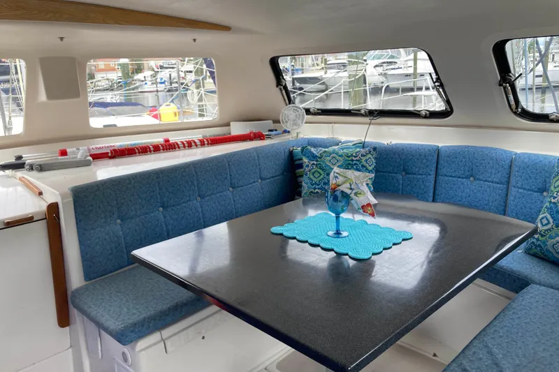 Slide: The Image of Interior of 2009 Seawind 36 1000XL catamaran with blue seating and dining table. - 18