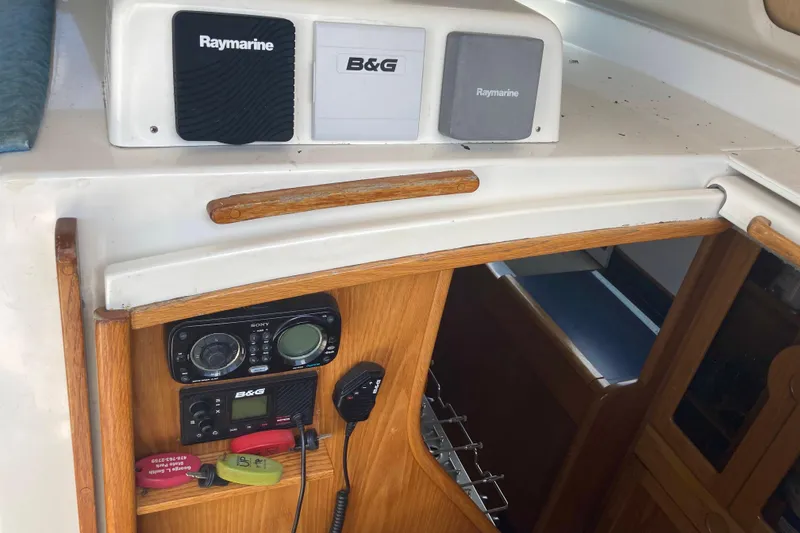 Slide: The Image of 2009 Seawind 36 1000XL yacht interior with navigation equipment and wooden cabinetry. - 19