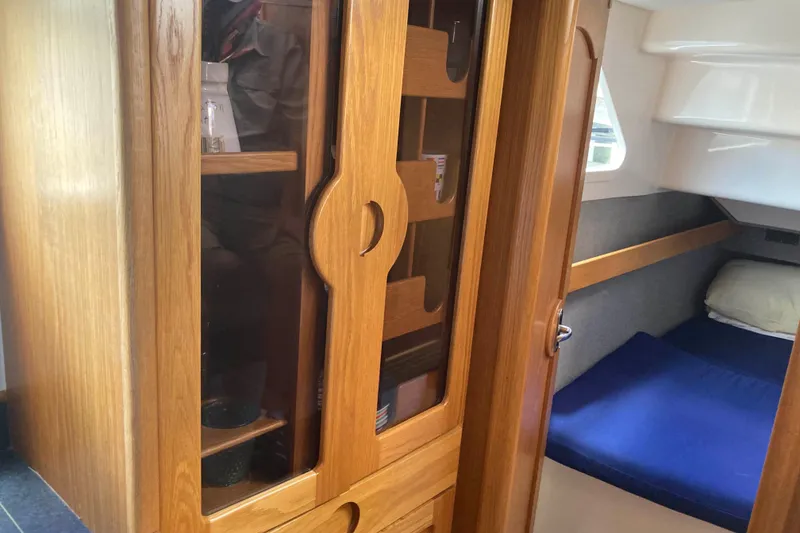 Slide: The Image of Interior of 2009 Seawind 36 1000XL yacht with wooden cabinetry and cozy sleeping area. - 23