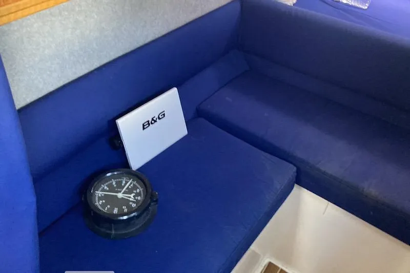 Slide: The Image of Interior of 2009 Seawind 36 1000XL with blue seating and navigation equipment. - 27