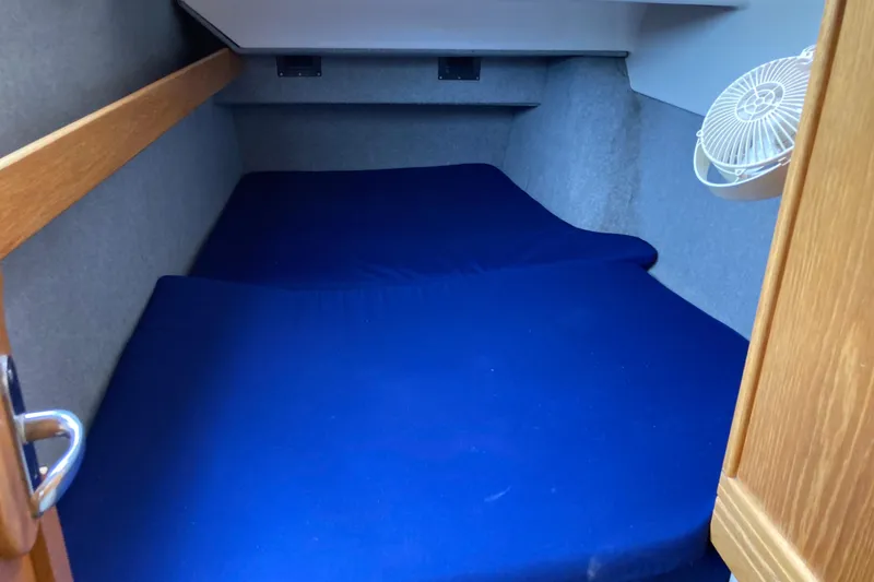 Slide: The Image of Cozy cabin interior of 2009 Seawind 36 1000XL with blue bedding and fan. - 28